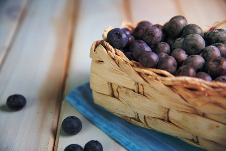 Fresh organic blueberries in basket on kitchen tableの写真素材