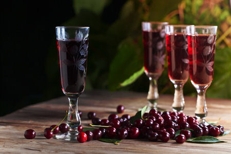 cherry brandy and ripe berries on  wooden tableの写真素材