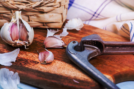 fresh garlic and squeezer on tableの写真素材