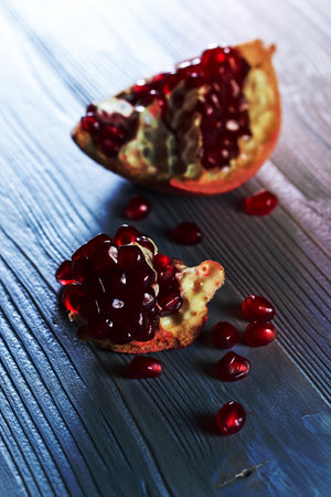 ripe pomegranate on a old wooden tableの写真素材
