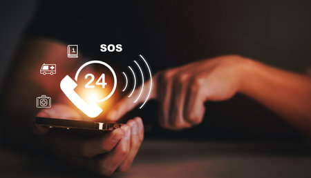 Hand touch button Emergency app in home, call phone, Chat message icon, Emergency application from smartphone for elderly, technology concept.Old hand touch mobile phone and call for help.の写真素材