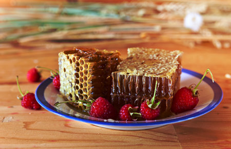 honey and raspberry on a wooden table