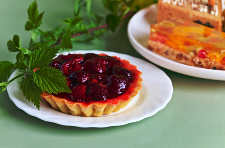 raspberry pie and green twig on kitchen tableの写真素材