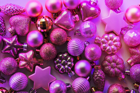 Christmas decoration balls different shapes in neon rays. Top view. Xmas pattern. Happy New Year.の写真素材