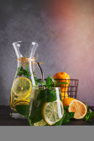 Infused water with lemon and mint in glass. Close up. Healthy detox drink for morning.の写真素材