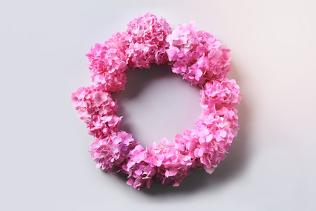 Pink hydrangea flowers as wreath on grey background with copy space. View from above. Greeting Card.の写真素材