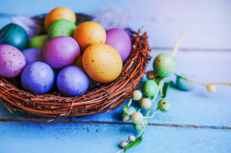 easter eggs in the nest on blue wooden background