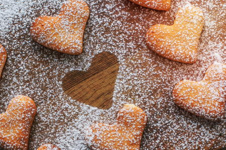 heart shaped cookies poweder with sugar one silhouette on wood backgroundの写真素材