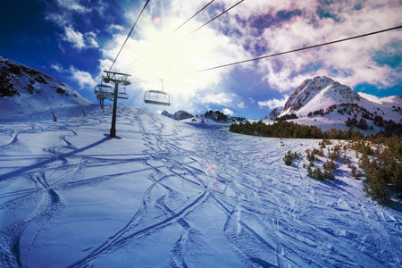ski lift on a snow covered mountainの写真素材