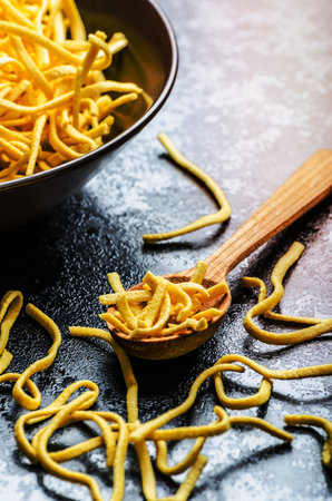 raw pasta on spoonの写真素材