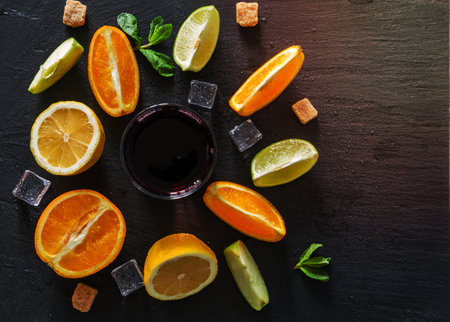 sangria ingredients orange lemon and lime slices wine sugar mint dark stone background top viewの写真素材