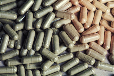 Herbal medicine background. Gotu Cola (Centella Asiaticapowder ) Herbal pills. Toned image.の写真素材