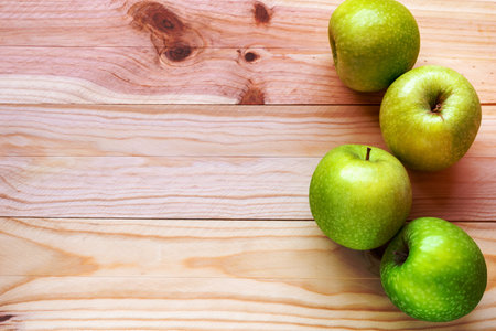 Tasty green apples on a wooden table. Top view, copy space.の写真素材