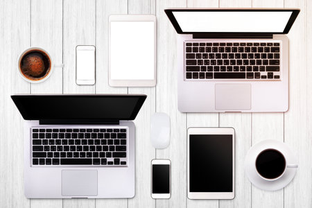 Laptop tablet smartphone eyeglass and coffee on wood table background with text space and copy spaceの写真素材