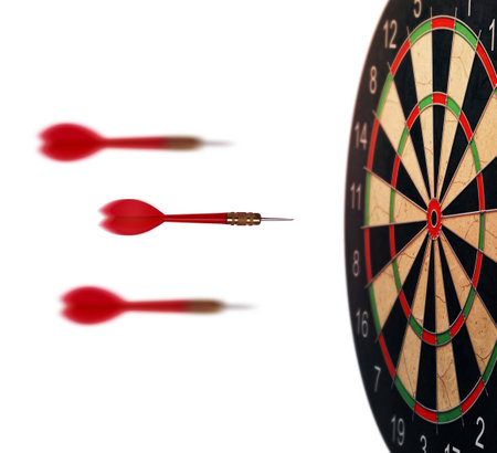 red dart arrows flying to target dartboard. Metaphor to target success, winner concept. Isolated on white backgroundの写真素材
