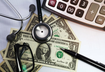 Pen stethoscope glasses and dollar on white backgroundの写真素材