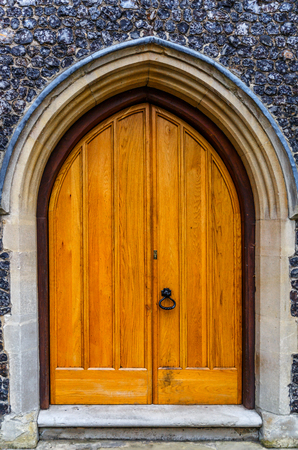 Large old wooden door in yellow color, in a villageの写真素材