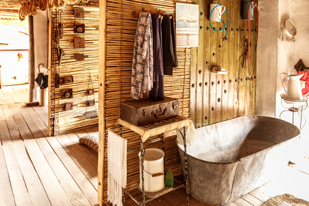 Old bathtub next to many other vintage utensilsの写真素材