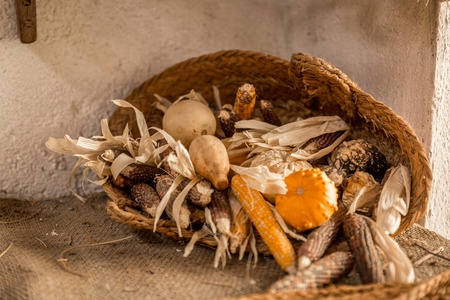 Basket with dried ears and other food, on an old surfaceの写真素材