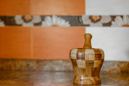 Cute wooden mortar on a kitchen counterの写真素材