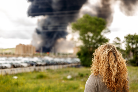 A huge and dangerous fire in the midst of a large population, is witnessed by a woman
