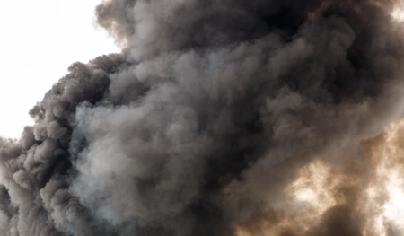 A dense and strong smoke from a fire, covering a parkの写真素材