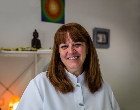 A woman therapist smiles at the consultation of a therapy centerの写真素材