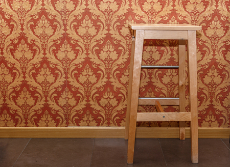 Large brown stool in the waiting room of a local, where tattoos are madeの写真素材