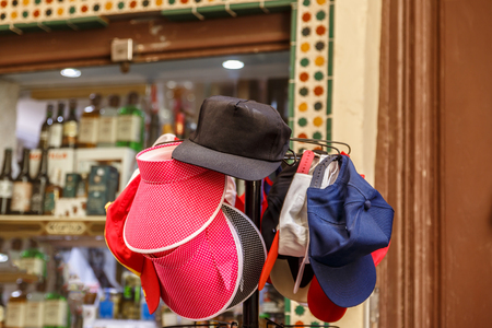 Set of caps of different colors in front of a showcaseの写真素材