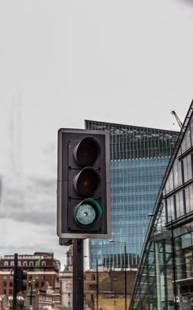 Green traffic light in the middle of a big cityの写真素材