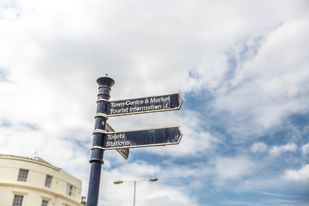 Signs on a street showing the way to the city center, England