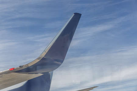 Tails of two large commercial flying airplanes
