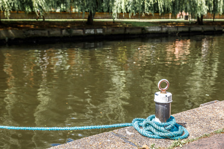 Small mooring with a blue rope on a river in England, UK