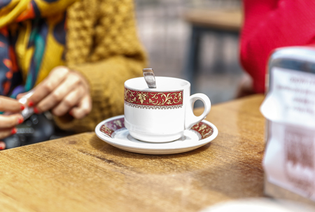 Typical cup of coffee on a wooden table