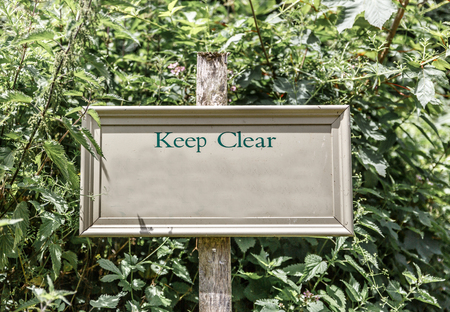 Sign in the middle of the nature that indicates Keep Clear in a sunny day, UKの写真素材