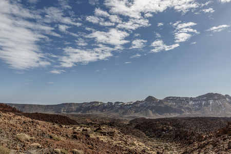Desert landscape with big mountains in the background on a sunny day on the island of Tenerife, Canary Islandsの写真素材