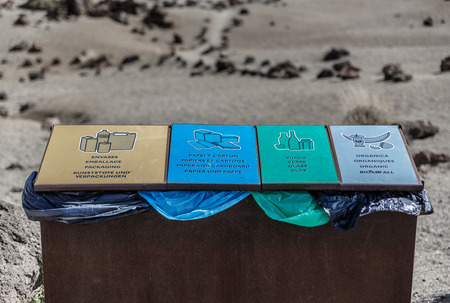 Garbage container with compartments for different types of garbage, in the middle of a desert areaの写真素材