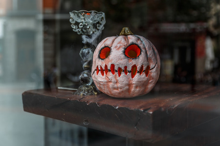 Pumpkin painted white and red, ready for the big Halloween party on October 31の写真素材