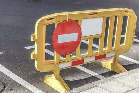 Forbidden sign the passage placed on a small yellow barrier