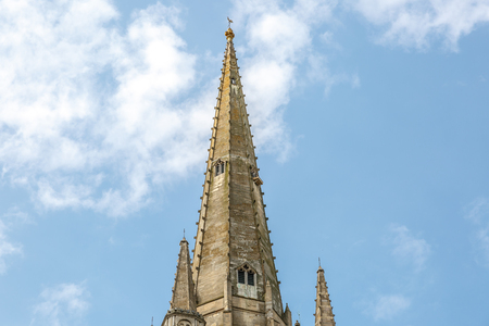 Tower of the medieval style catholic cathedral of the city of Norwich, with the blue sky in the backgroundの写真素材