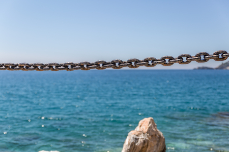 Chain in a coastal area, with a calm sea in the background, Spainの写真素材