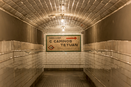 Corridor in an old subway station, lit with a dim light
