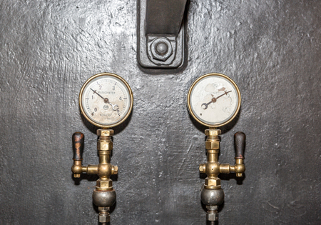 Old valves and gauges placed in a subway machine control roomの写真素材