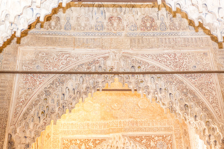 Arch with arabesque caligraphy and Mocarabe honeycomb designs in Comares Palace of Nasrid Alhambra Granada, Andalusia, Spainのeditorial素材