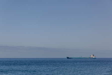 View of a huge distant ship in a calm sea with a clear sky, Spainの写真素材