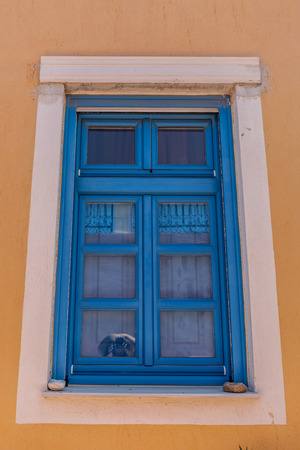 Typical blue window of a house in the town of Oia, on the island of Santorini, Greeceの写真素材
