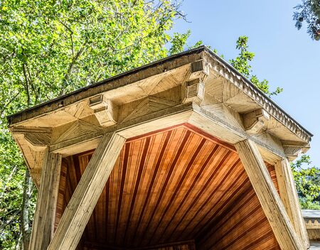 Oriental style structure in the middle of a lush park on a sunny summer day