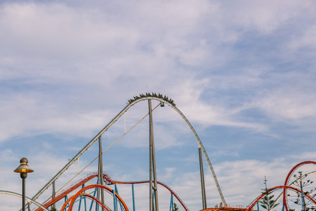 Roller coaster in a large amusement park in a sunny dayの写真素材
