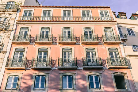 Pretty pink facade of an old residential building in the European city of Lisbon, Portugal