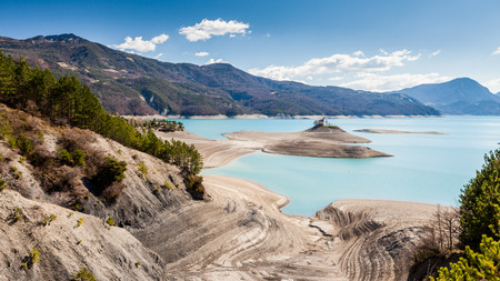Lake Serre-Poncon and a small church on a island, Hautes-Alpes, Franceの写真素材
